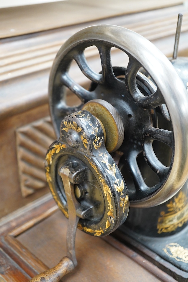 An early 20th century cased Singer sewing machine, 46cm wide at base. Condition - poor